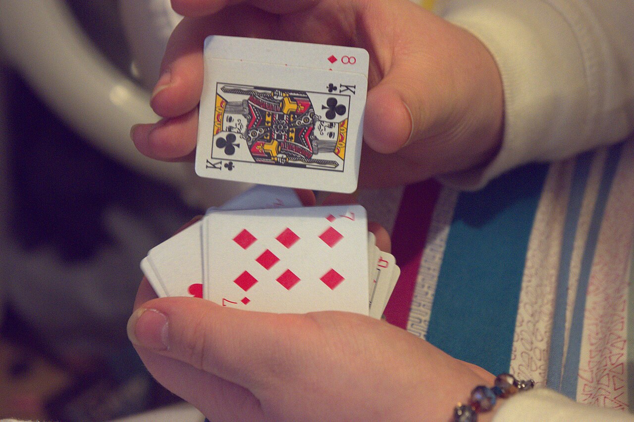 Hands shuffling a deck of playing cards