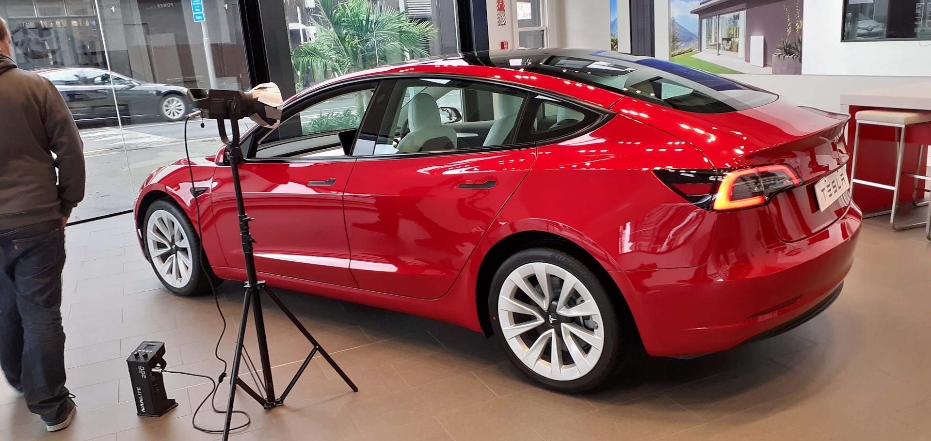 A Tesla showroom with a Model 3 on display