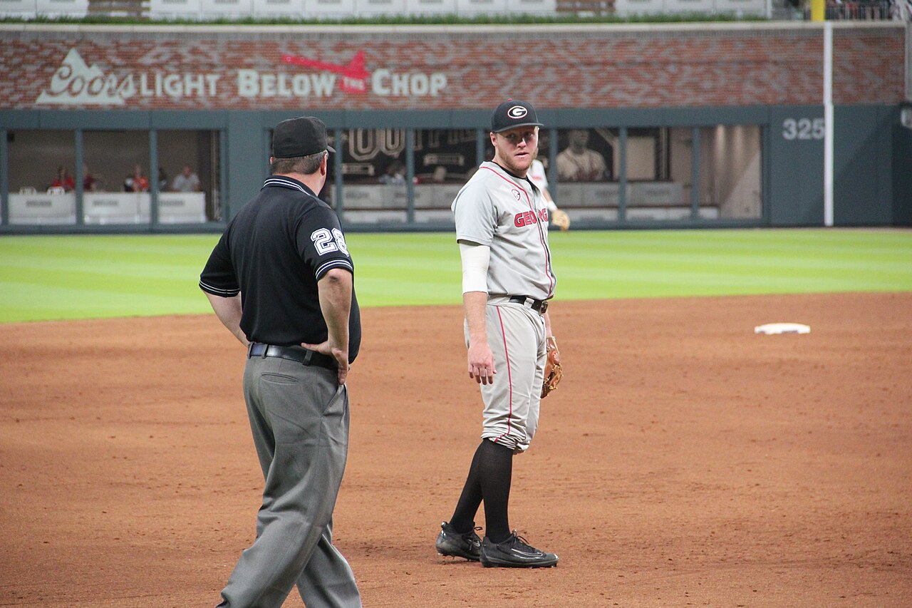 A baseball umpire calling a play at the plate