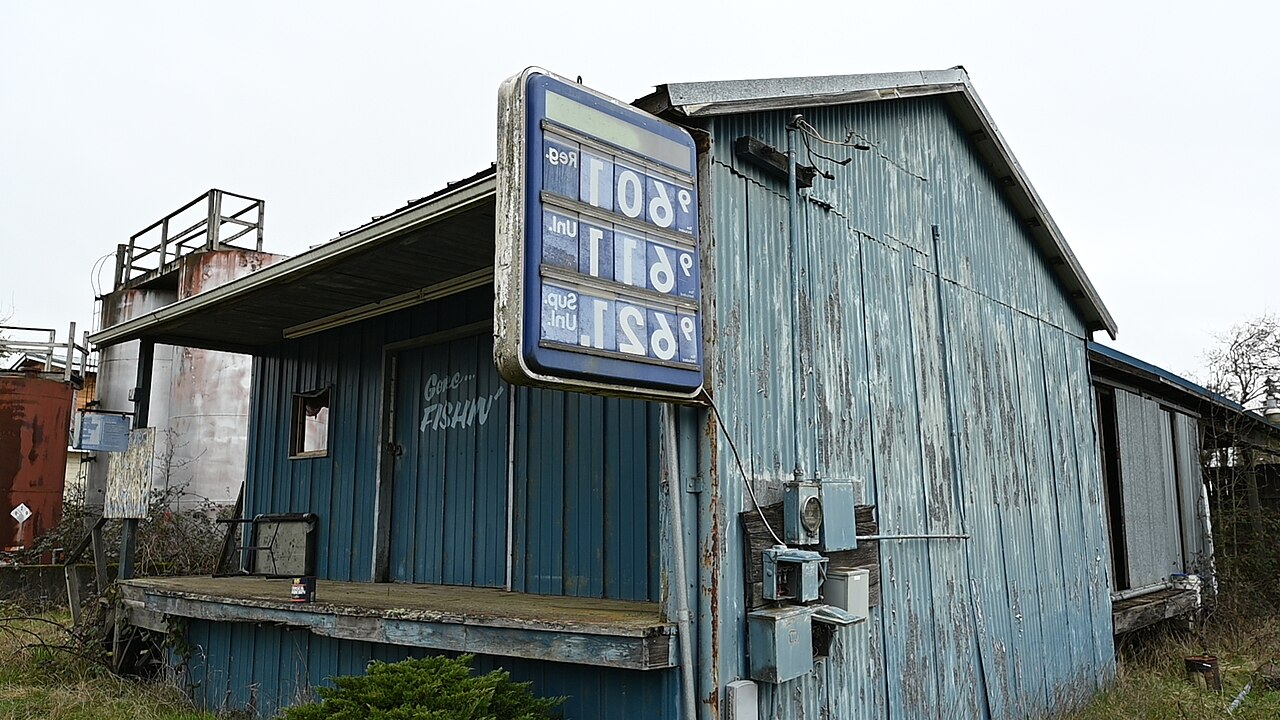 Gas station price sign showing per-gallon prices